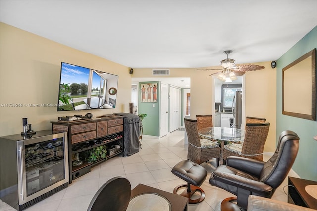 dining area featuring light tile patterned flooring, beverage cooler, and ceiling fan