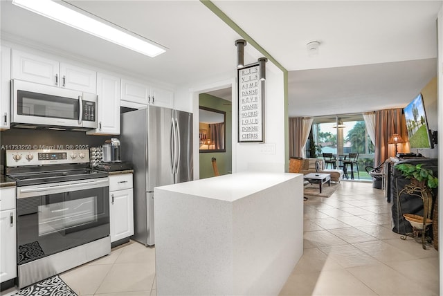 kitchen with white cabinetry, appliances with stainless steel finishes, and light tile patterned floors