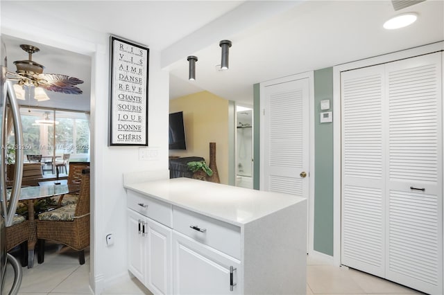 kitchen featuring white cabinetry, ceiling fan, kitchen peninsula, and light tile patterned floors