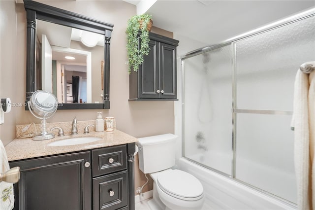 full bathroom with vanity, toilet, and combined bath / shower with glass door