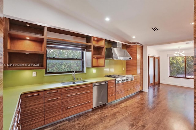 kitchen featuring wall chimney exhaust hood, sink, vaulted ceiling, dark hardwood / wood-style flooring, and stainless steel appliances