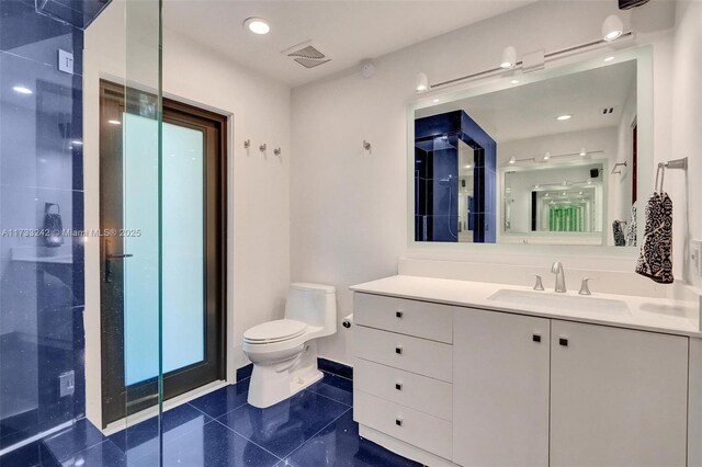 bathroom with vanity, tile patterned floors, and toilet