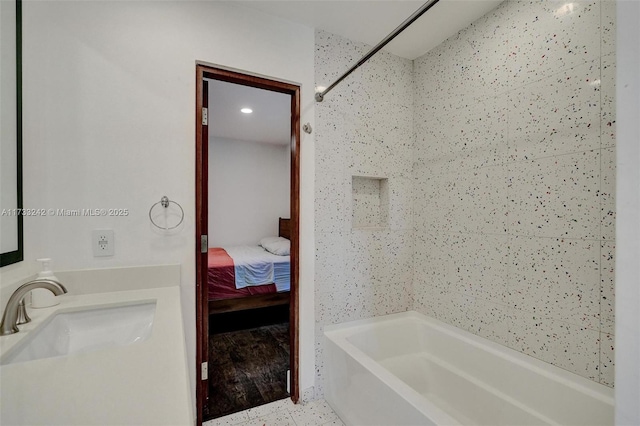 bathroom featuring tiled shower / bath and sink