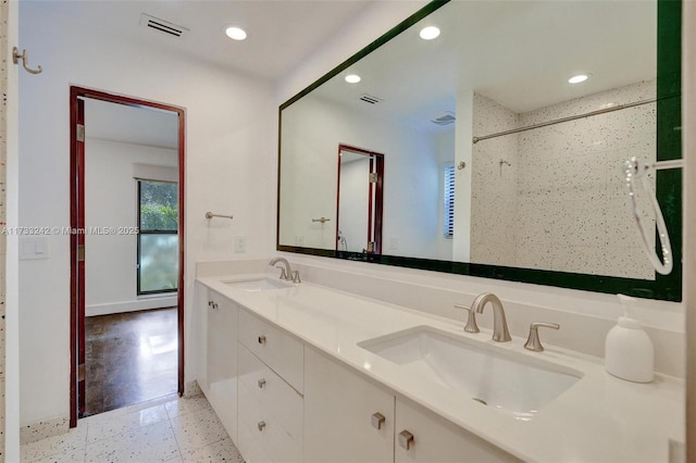 bathroom with vanity and a shower