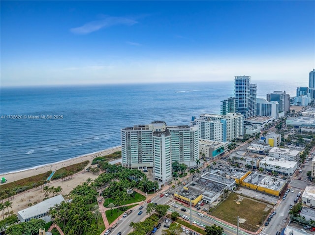 drone / aerial view with a beach view and a water view