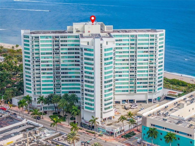 birds eye view of property with a water view and a view of the beach