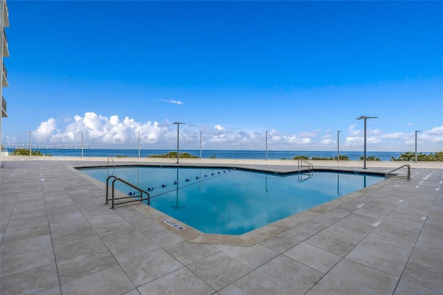 view of swimming pool with a water view