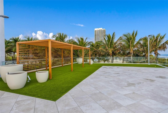 exterior space featuring a patio, a pergola, and a lawn