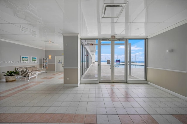 interior space with a water view, a wall of windows, ornamental molding, and light tile patterned floors