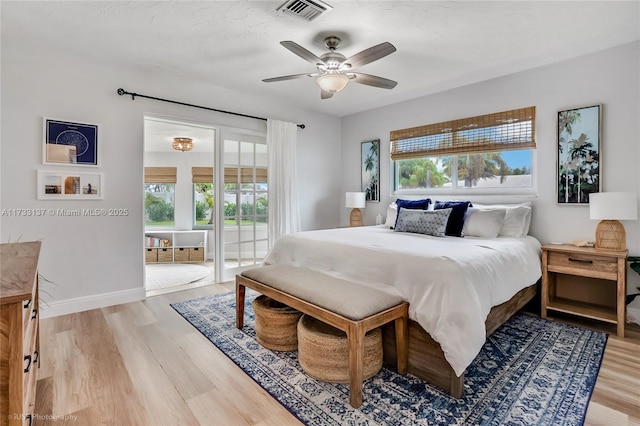 bedroom featuring access to outside, hardwood / wood-style floors, a textured ceiling, and ceiling fan