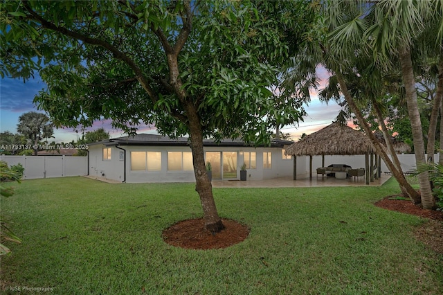 yard at dusk with a gazebo and a patio