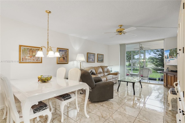 living room with floor to ceiling windows, ceiling fan with notable chandelier, and a textured ceiling