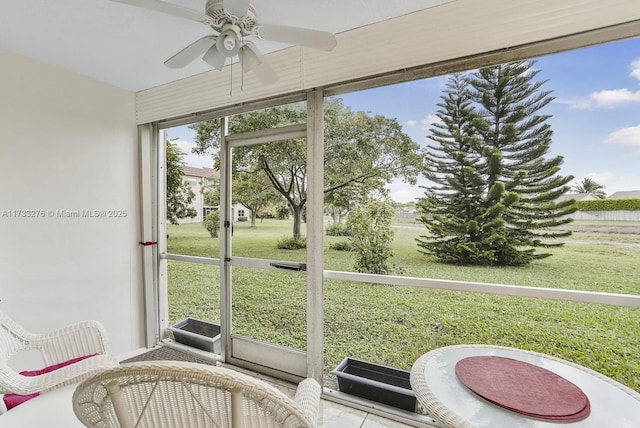 sunroom featuring ceiling fan