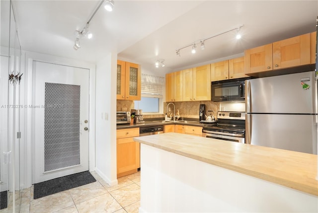 kitchen featuring light tile patterned floors, sink, wooden counters, stainless steel appliances, and light brown cabinets