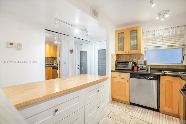 kitchen with backsplash, wooden counters, dishwasher, and white cabinets