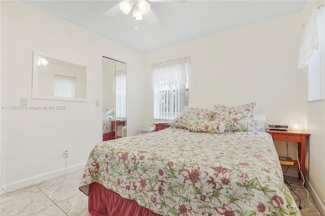 bedroom featuring ceiling fan and a closet