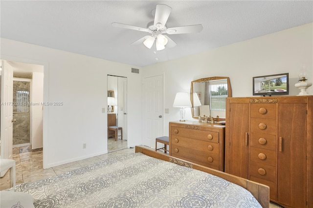 bedroom with light tile patterned flooring, a textured ceiling, ceiling fan, and a closet