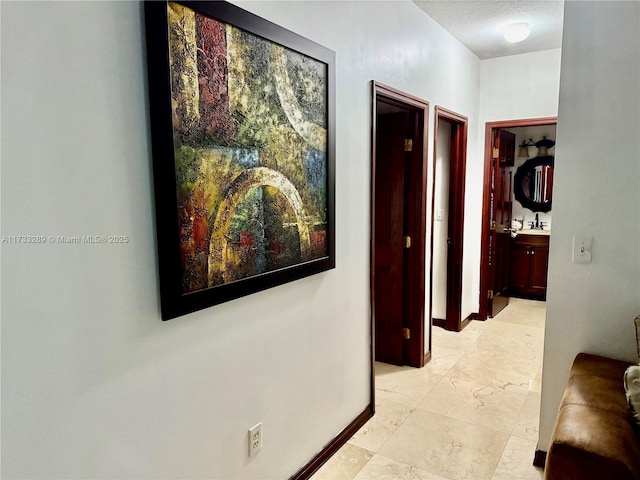 corridor with a textured ceiling