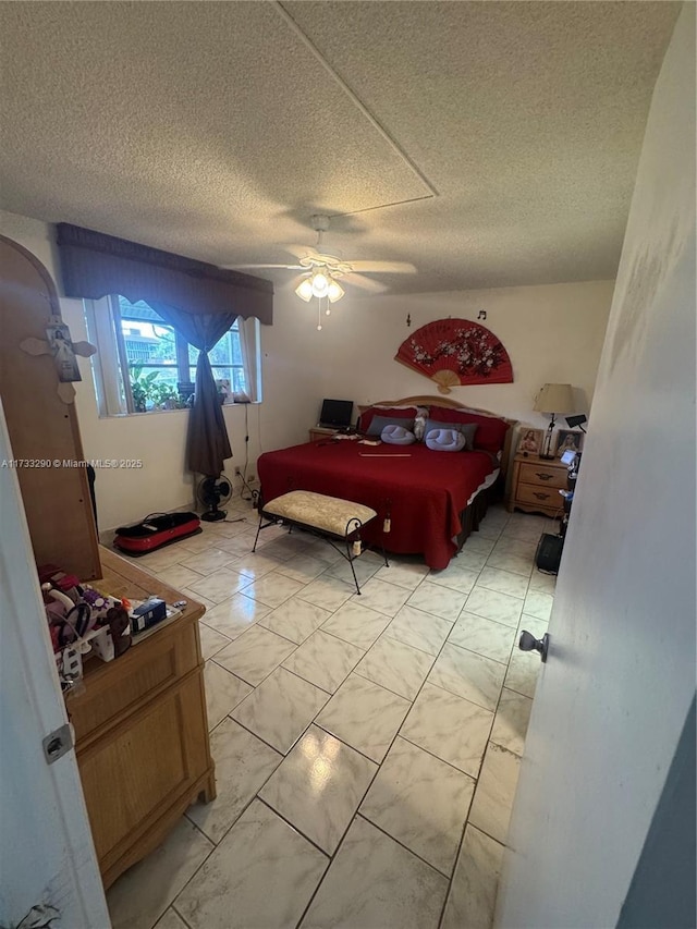 bedroom with a textured ceiling and ceiling fan