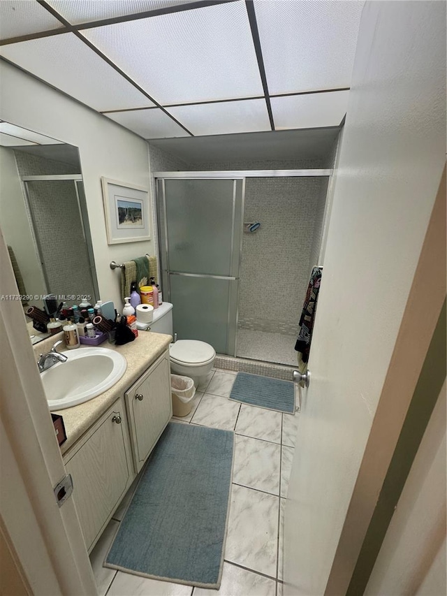 bathroom featuring vanity, tile patterned floors, toilet, and walk in shower