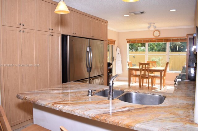 kitchen with sink, hanging light fixtures, light tile patterned floors, appliances with stainless steel finishes, and kitchen peninsula