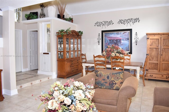 living room with light tile patterned floors and crown molding