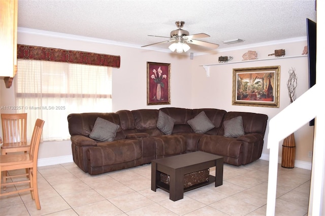 tiled living room featuring ceiling fan, ornamental molding, and a textured ceiling