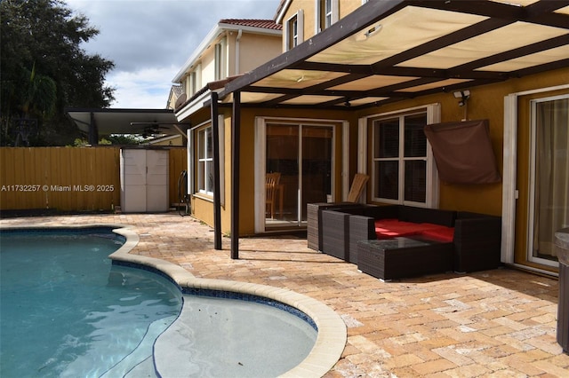 view of pool with a patio and ceiling fan