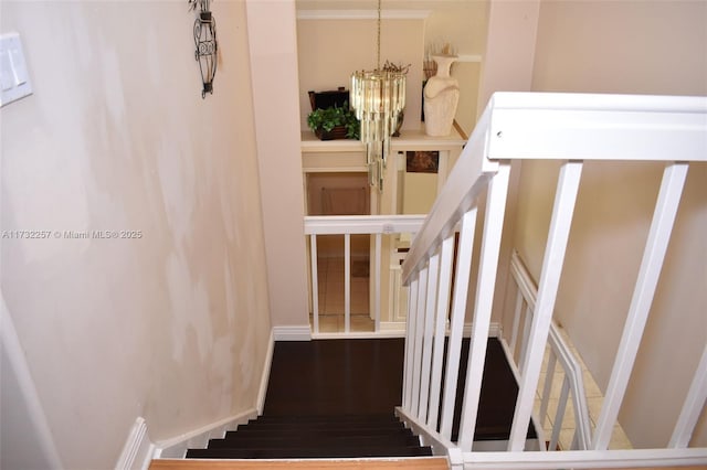 stairs featuring an inviting chandelier