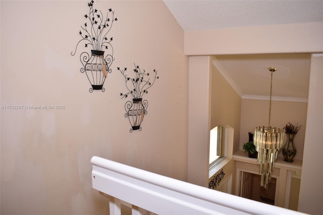 details with ornamental molding, a textured ceiling, and a notable chandelier