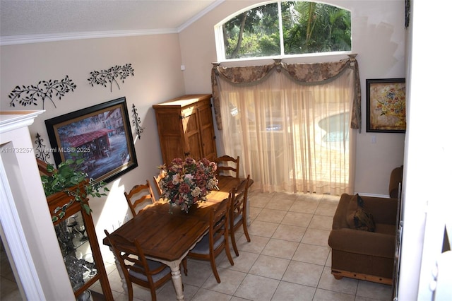 dining room with crown molding, a textured ceiling, and light tile patterned flooring