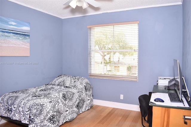 bedroom featuring ornamental molding, light wood-type flooring, a textured ceiling, and ceiling fan