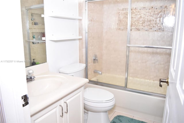 full bathroom with vanity, tile patterned floors, shower / bath combination with glass door, and toilet