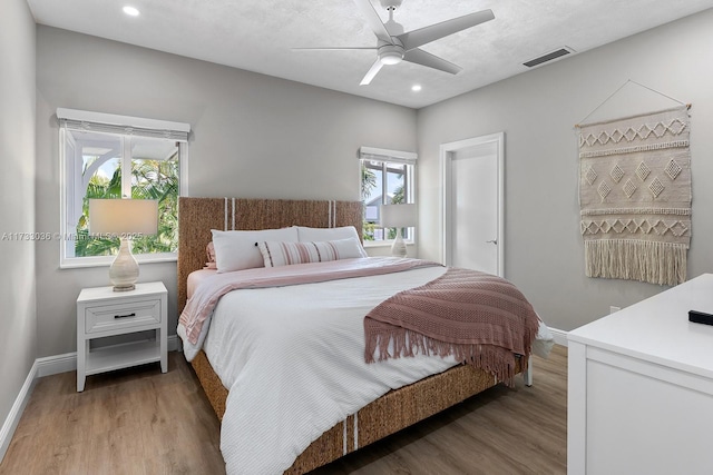 bedroom with baseboards, recessed lighting, visible vents, and light wood-style flooring