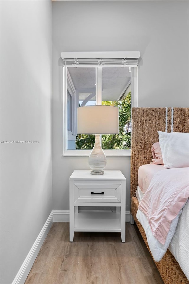 interior space with baseboards and wood finished floors