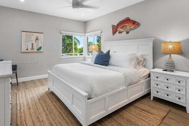 bedroom with baseboards, wood finished floors, recessed lighting, and ceiling fan
