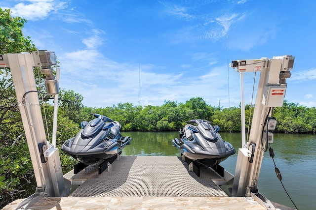 view of dock with boat lift and a water view