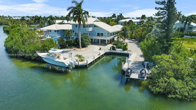 back of house with a water view and a balcony
