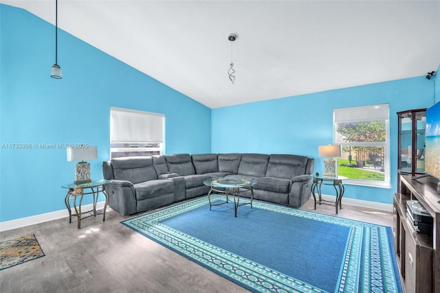 living room featuring hardwood / wood-style flooring and vaulted ceiling