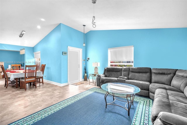 living room featuring lofted ceiling and wood-type flooring