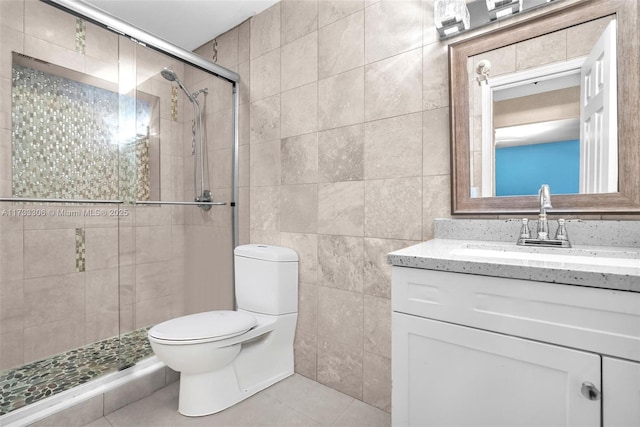 bathroom with tile patterned flooring, toilet, tile walls, and walk in shower