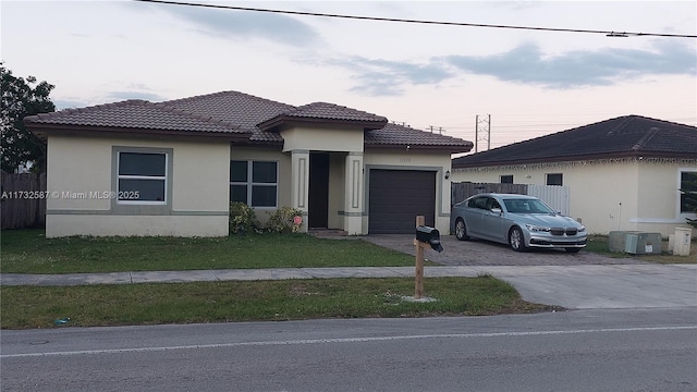 view of front of home with a garage and a front lawn