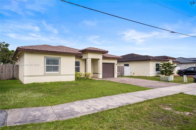 view of front of property with a garage and a front lawn