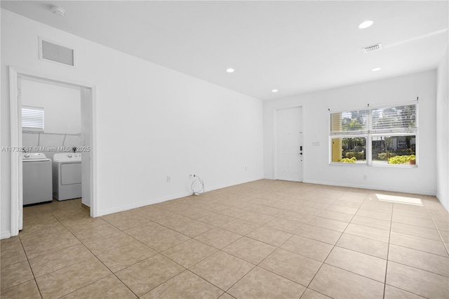 tiled spare room with independent washer and dryer