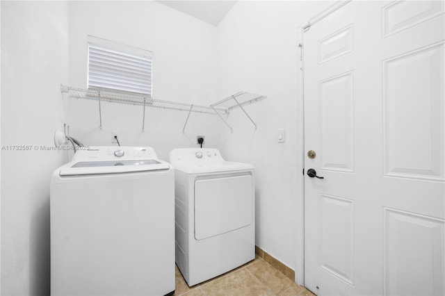 washroom featuring light tile patterned floors and washer and dryer