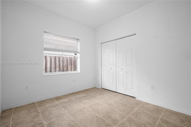 unfurnished bedroom with a closet and light tile patterned floors