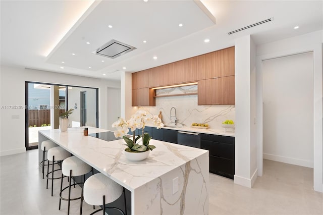 kitchen featuring wine cooler, black appliances, a breakfast bar, and a large island with sink