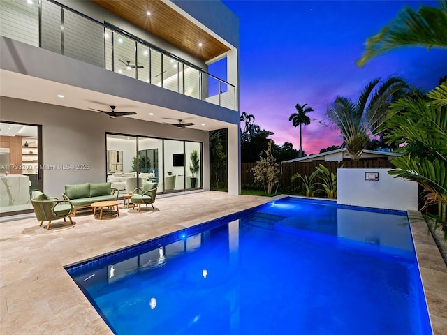 view of swimming pool featuring ceiling fan, an outdoor living space, and a patio