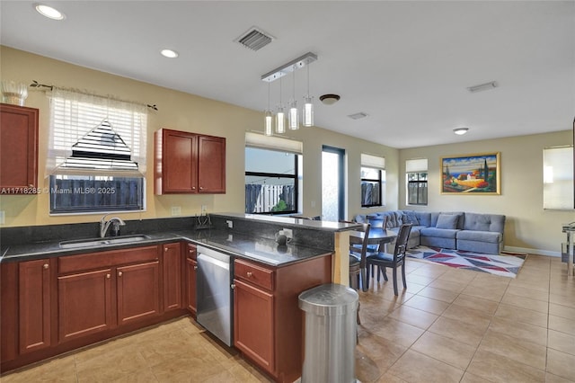 kitchen with pendant lighting, sink, stainless steel dishwasher, light tile patterned floors, and kitchen peninsula