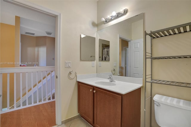 bathroom featuring vanity, hardwood / wood-style flooring, and toilet